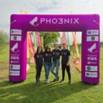 Harmony Energy staff standing at the finish line of the Brownlee Foundation mini triathlon.